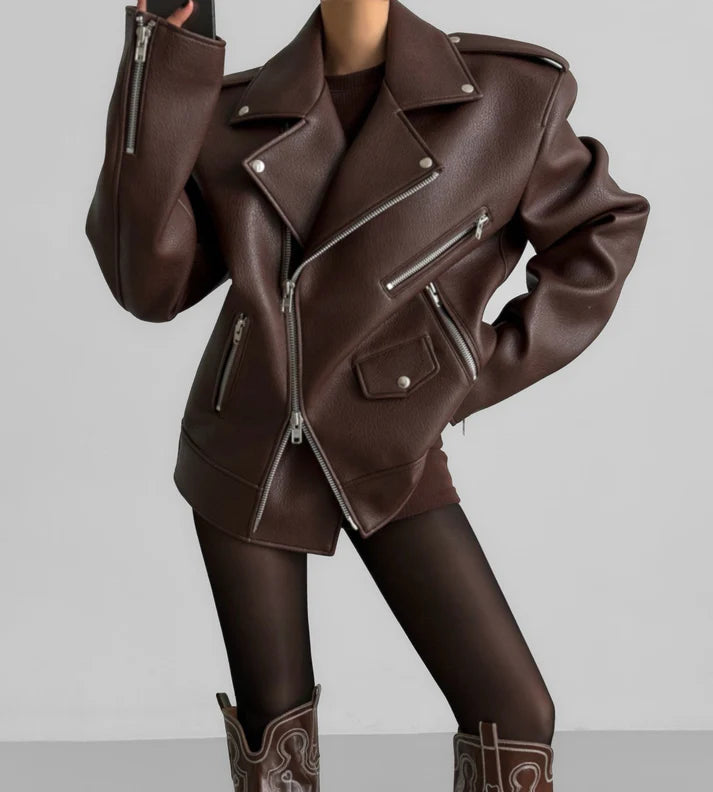 Brown leather jacket with zippers on a plain background