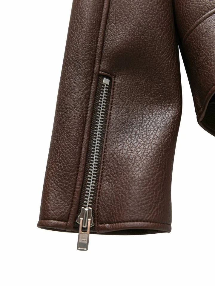 Close-up of a brown leather jacket with a zipper on a white background