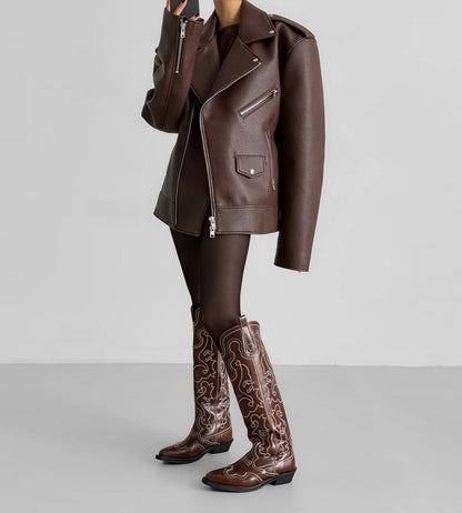Brown leather jacket and boots on a plain background