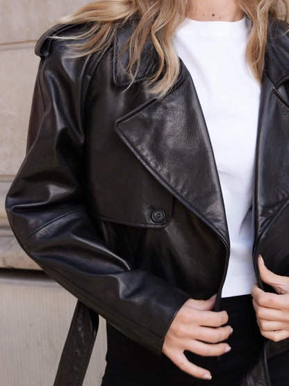 Black leather jacket worn by a person with a neutral background