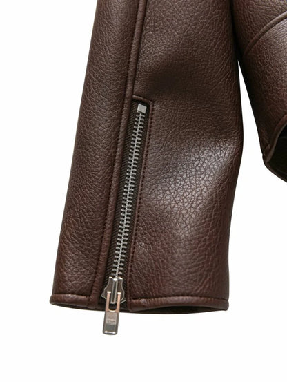 Close-up of a brown leather jacket with a zipper on a white background