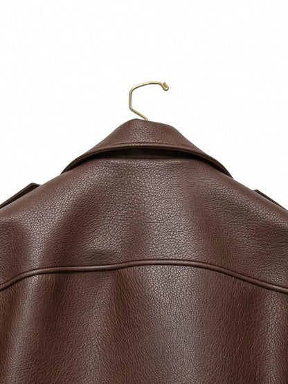 Brown leather jacket on a gold hanger against a white background
